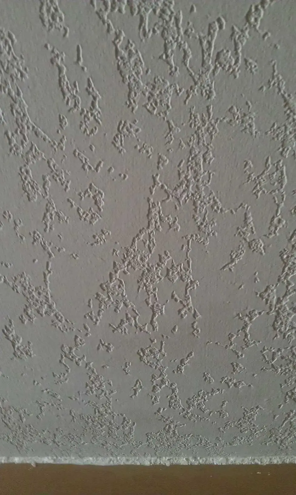 Close-up of knockdown texture on a finished drywall wall